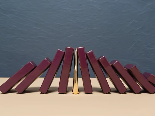 A golden form calmly interrupting a cascade of plum dominoes